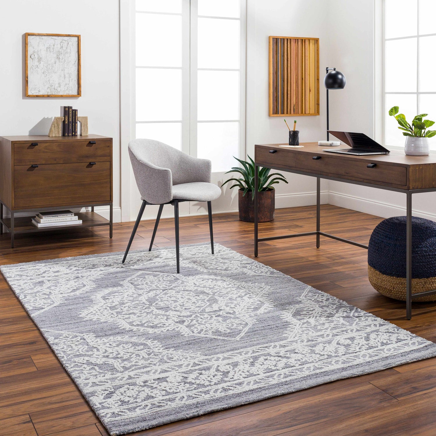Bright home office with Denae Blue Area Rug, wood desk and floors, gray chair, and large window. Roomscene-Rectangle