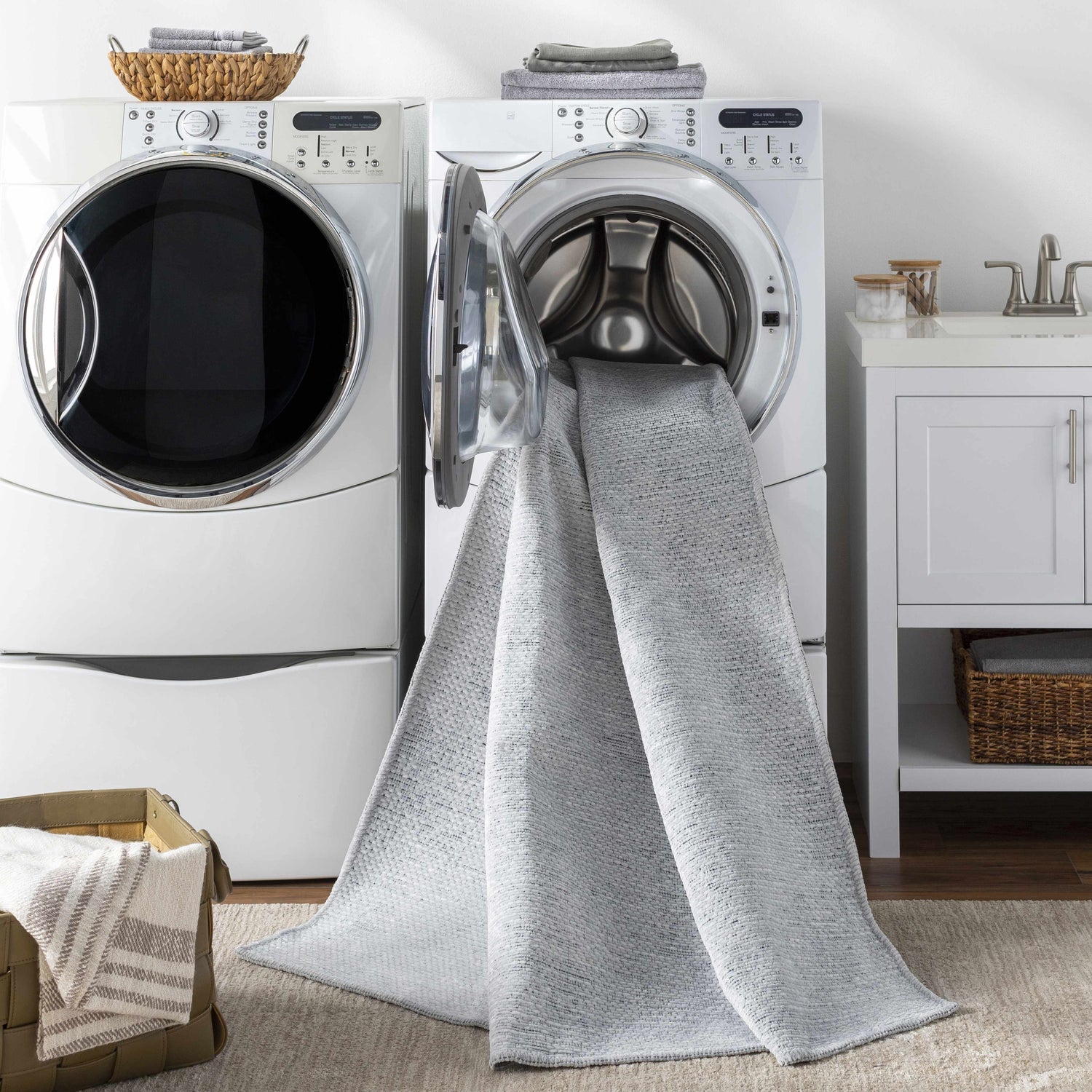 Laundry room scene with Isako Light Blue Washable Rug coming out of the washing machine. Modern, clean laundry room design. Washing-Machine