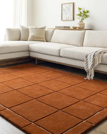 Living room scene with a cream sectional sofa and the Siarl Burnt Orange Checkered Area Rug. Roomscene-Rectangle