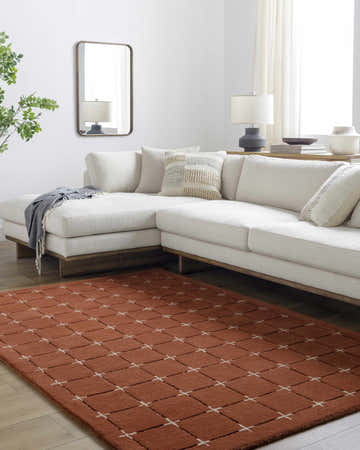 Living room scene with a peach Sanvi Wool Area Rug, white sofa, and neutral decor. Roomscene-Rectangle