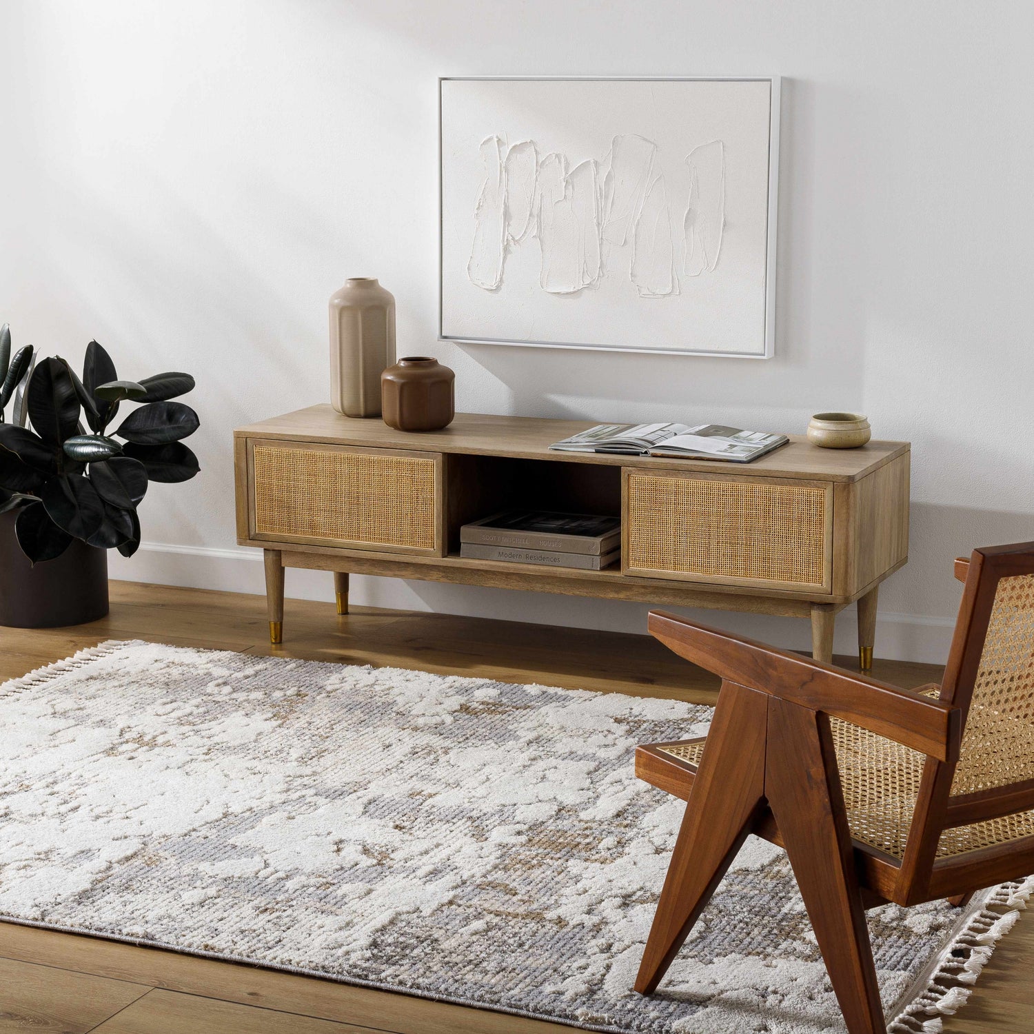 Living room scene with beige Idola Area Rug, wood media console, and mid-century modern chair. Roomscene-Rectangle