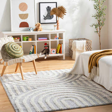 Kids bedroom with a geometric Arnel Gray & Beige Area Rug, white furniture, and playful decor. Roomscene-Rectangle