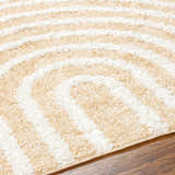 Close-up of the Arnel Beige Area Rug showing its bone and light brown geometric shag design and soft texture. Texture