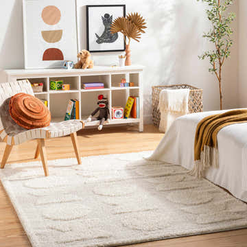 Kids bedroom scene with a white Dason Cream Area Rug, white shelving unit, toys, and a woven chair. Roomscene-Rectangle