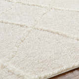 Close up of the shag texture and geometric pattern of the cloud gray Daube Area Rug. Texture