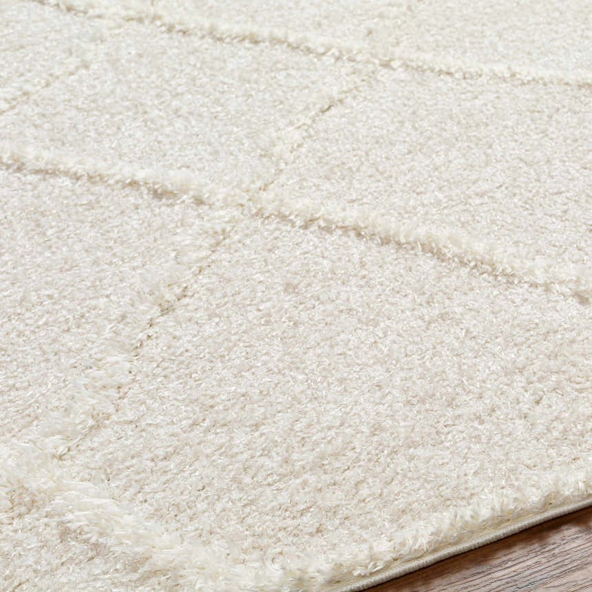 Close up of the shag texture and geometric pattern of the cloud gray Daube Area Rug. Texture