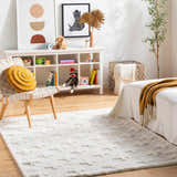 Kids room with white shelving, toys, and Satu Cream Area Rug, creating a cozy, neutral, and playful space. Roomscene-Rectangle