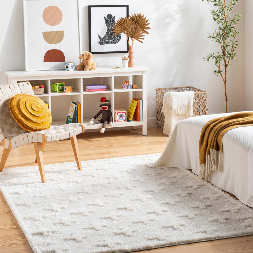Kids room with white shelving, toys, and Satu Cream Area Rug, creating a cozy, neutral, and playful space. Roomscene-Rectangle