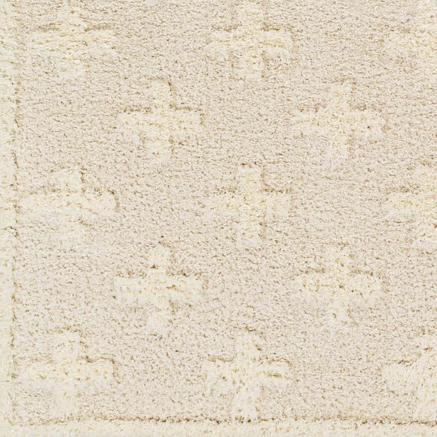 Close-up of the Satu Cream Area Rug. Shag rug with geometric pattern in bone, driftwood, gray, and nutmeg hues. Soft texture. Swatch