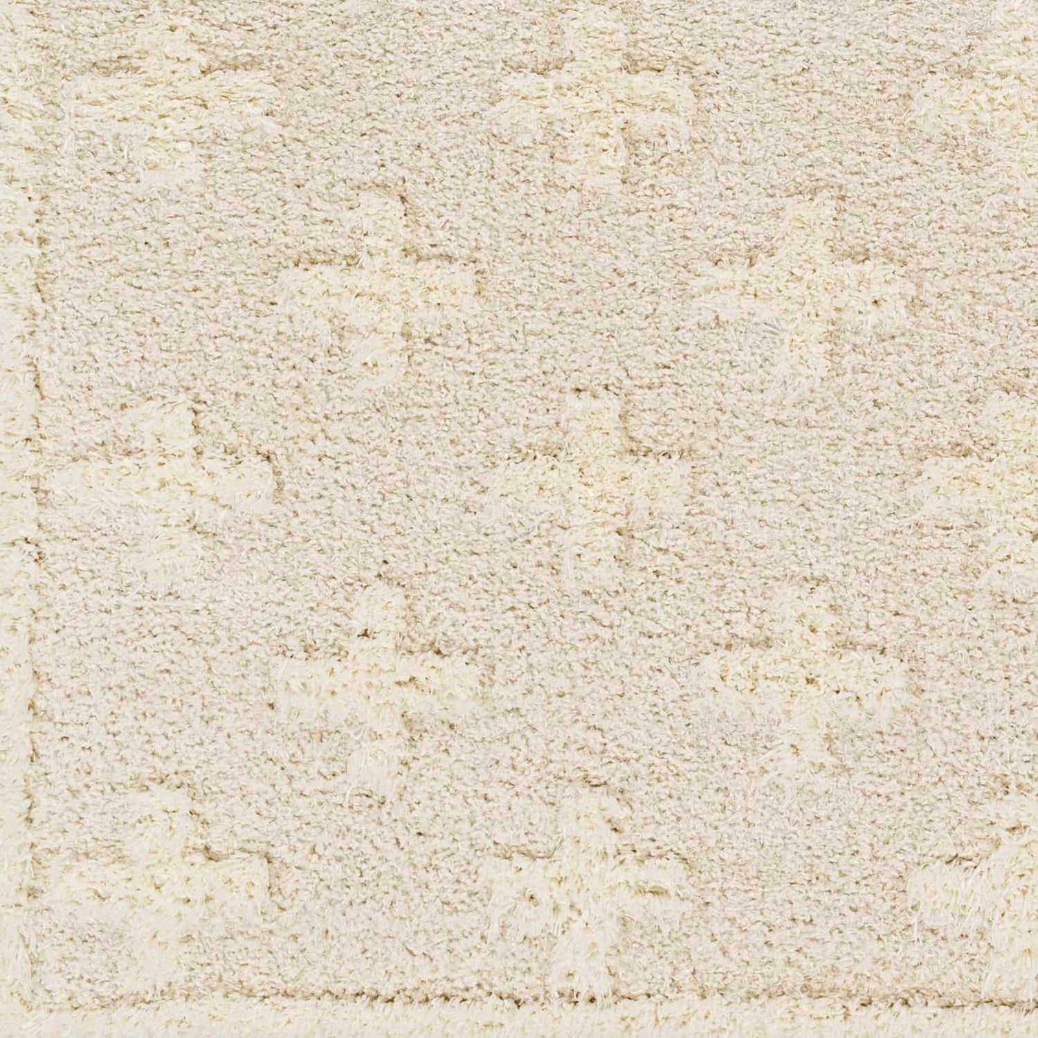 Close-up of the Satu Cream Area Rug. Shag rug with geometric pattern in bone, driftwood, gray, and nutmeg hues. Soft texture. Swatch