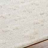 Close up of the cream Satu shag rug showing its soft, textured pile. Texture