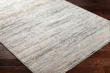 Close-up of Fizza Area Rug: beige, bone, and gray contemporary rug with subtle linear pattern on dark wood floor. Corner
