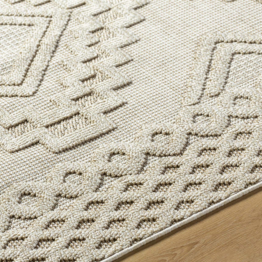 Close-up of Arwid Bone Area Rug showing beige geometric pattern and textured weave on wood floor. Texture