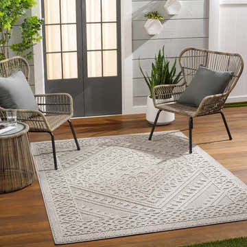 Patio scene with Hibah Natural Gray Area Rug, wicker chairs, wood floors, and gray accents. Roomscene-Rectangle