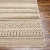 Close-up of Kojo Lambswool Area Rug in camel. Features a contemporary geometric pattern and textured weave on wood floors. Front
