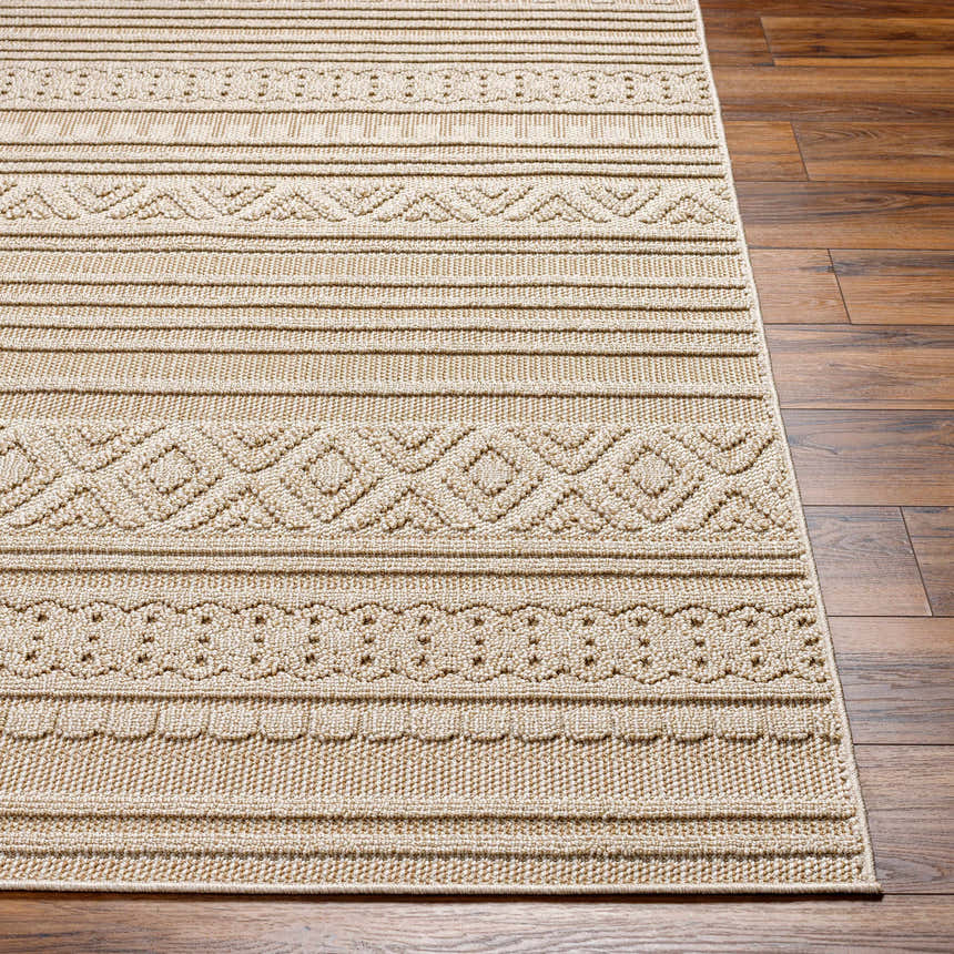 Close-up of Kojo Lambswool Area Rug in camel. Features a contemporary geometric pattern and textured weave on wood floors. Front