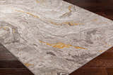 Close-up of Akins Beige Marble Rug showing swirling gray, beige, and gold pattern on dark wood floor. Contemporary style. Corner