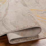 Close-up of the Akins Beige Marble Rug showing its neutral tones, subtle marble pattern, and texture. Fold