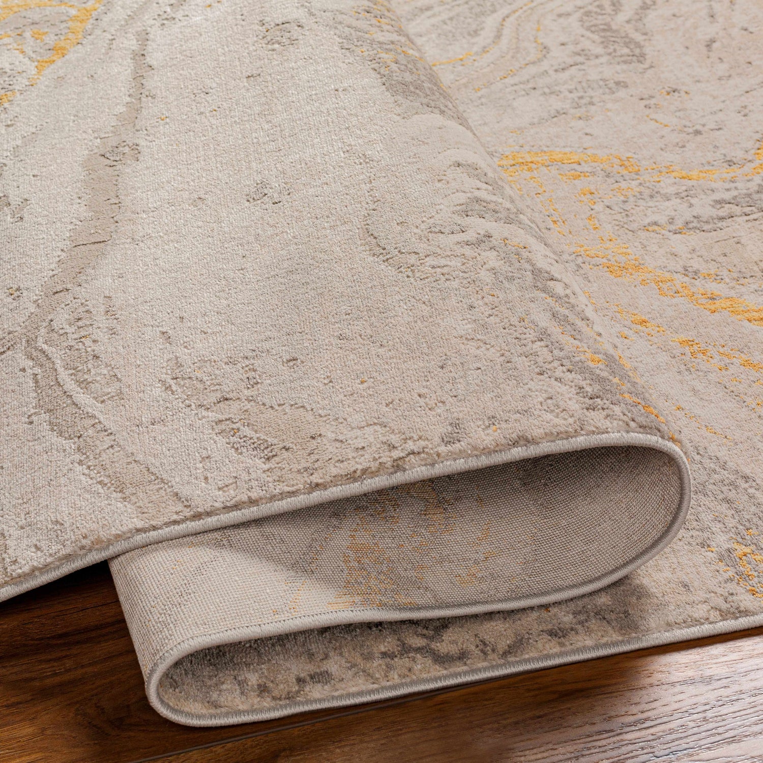 Close-up of the Akins Beige Marble Rug showing its neutral tones, subtle marble pattern, and texture. Fold