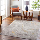 Living room scene with Akins Beige Marble Rug, gray chair, wood table, and plant, creating a contemporary, inviting space. Roomscene-Rectangle