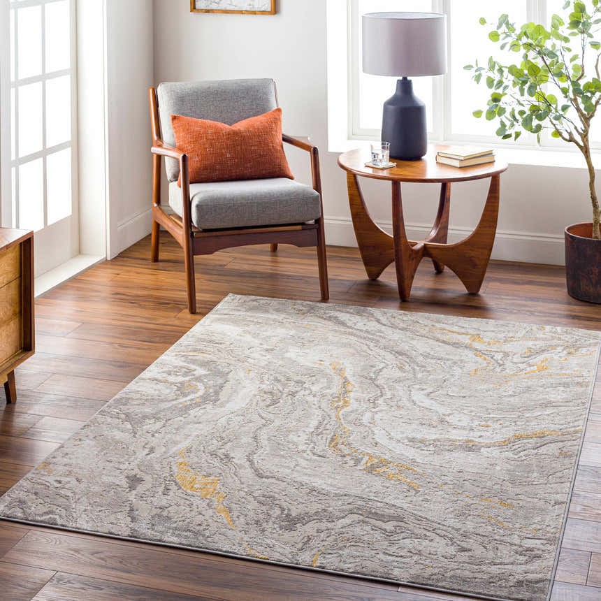 Living room scene with Akins Beige Marble Rug, gray chair, wood table, and plant, creating a contemporary, inviting space. Roomscene-Rectangle