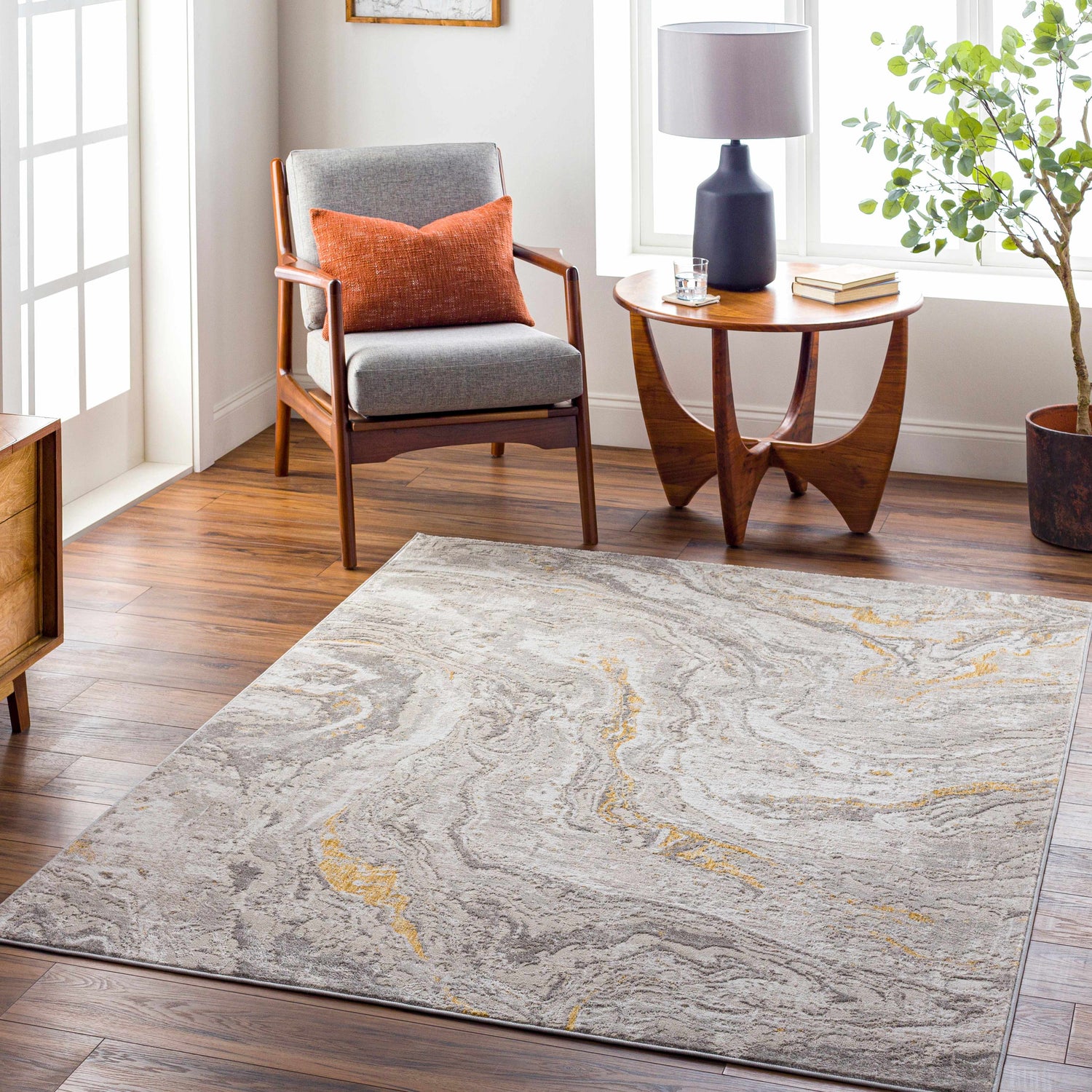 Living room scene with Akins Beige Marble Rug, gray chair, wood table, and plant, creating a contemporary, inviting space. Roomscene-Rectangle