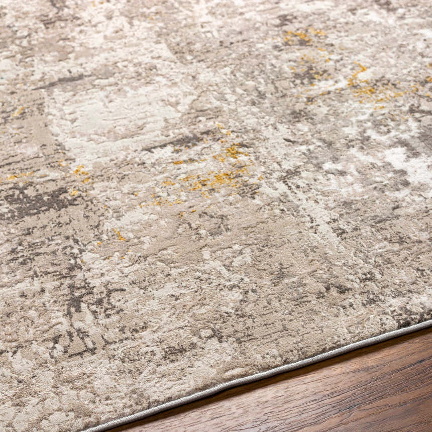 Close-up of the Yuji Area Rug showing its beige, gray, and nutmeg abstract pattern and soft texture. Texture