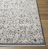 Close-up of the Haran Cloud Gray Area Rug, showcasing its traditional pattern, cloud gray and medium gray colors, and soft texture. Front