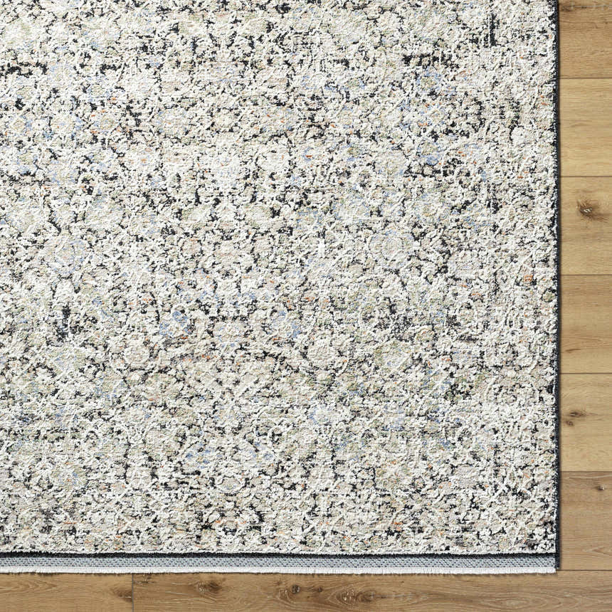 Close-up of the Haran Cloud Gray Area Rug showing its farmhouse style pattern and textured polyester material. Corner