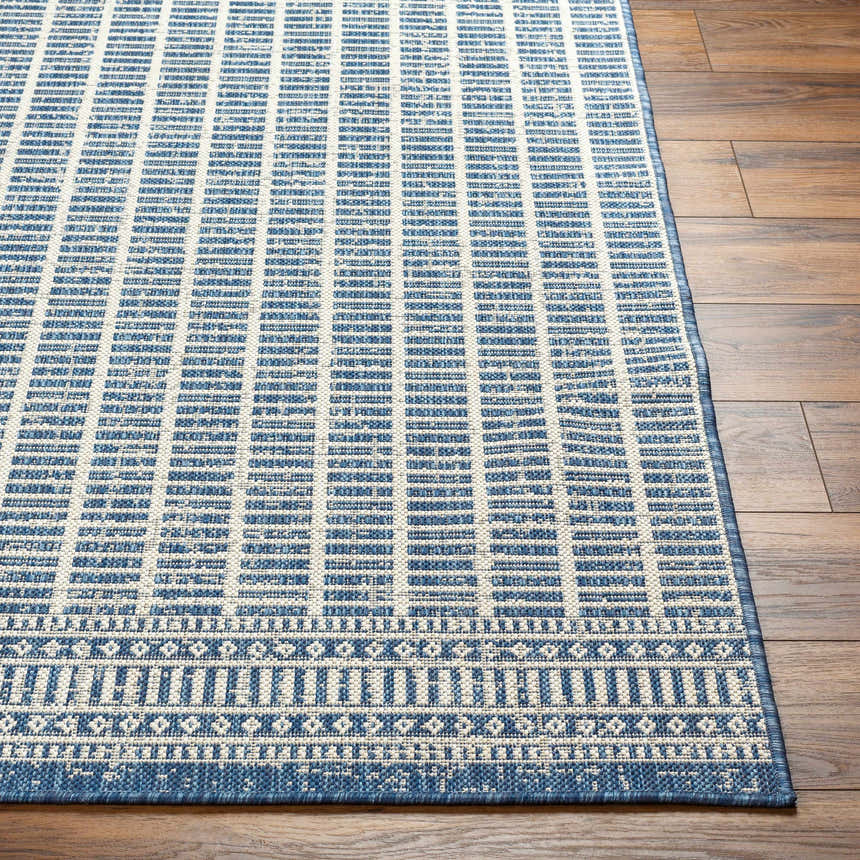Close-up of the Amena Blue Area Rug showing its geometric pattern and blue and beige color palette. Front