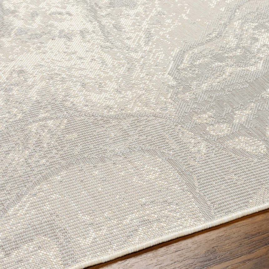 Close-up of the Basma Cream Marble Area Rug showing its beige, bone, and gray contemporary pattern and machine-woven texture. Texture