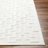 Close-up of the Diza Cream Outdoor Rug showing its geometric pattern and textured bone and driftwood colors. Front