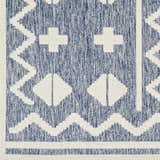 Close-up of Elio Blue Outdoor Rug, featuring a geometric pattern in denim blue and white. Contemporary style. Swatch