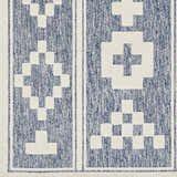 Close-up of the Hiro Blue Outdoor Rug showing its denim blue and white geometric pattern and woven texture. Swatch