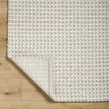 Close-up of the hand woven Lenci Wool Area Rug in beige and rose cream with a braided texture. Fold