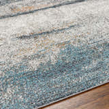 Close-up of the Adam Gray Blue Abstract Area Rug showing its gray, blue, and beige contemporary design. Texture