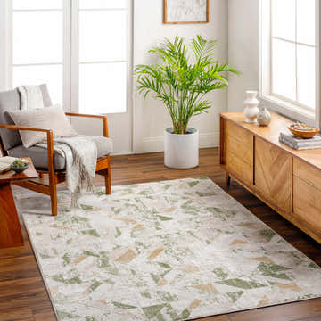 Living room scene with a Gonca Green Geometric Area Rug, gray chair, wood media console, and bright natural light. Roomscene-Rectangle