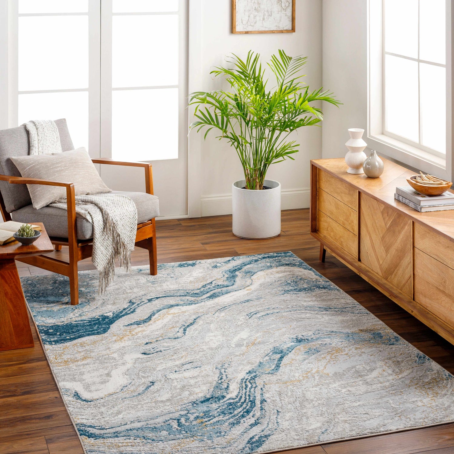 Living room with gray chair and Tess Silver Blue Marble Area Rug. Modern design. Roomscene-Rectangle