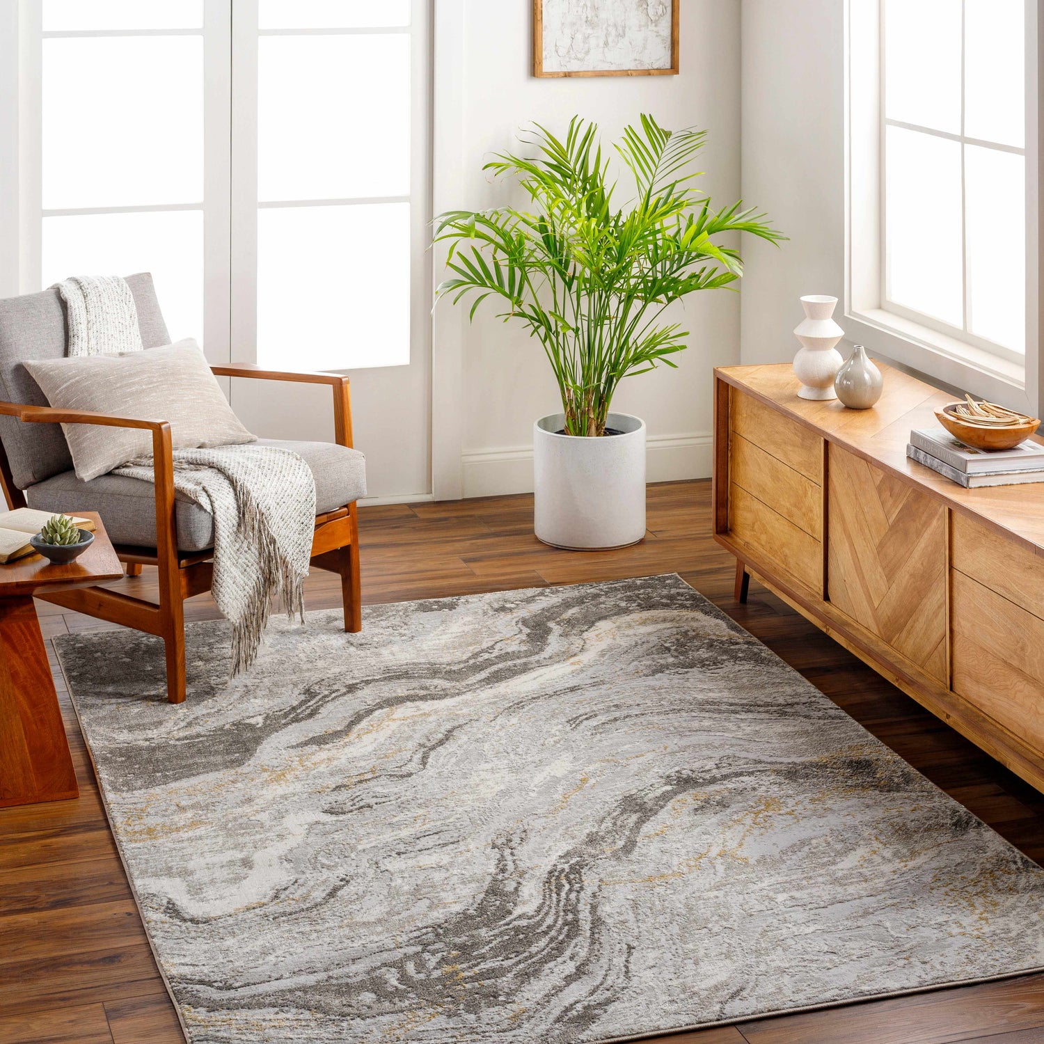 Living room scene with Tess Gray & Brown Marble Area Rug, gray armchair, wood console, and natural light. Roomscene-Rectangle