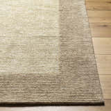 Close-up of the hand-tufted Amadi Area Rug. Neutral pearl and tan tones with a subtle striped design. 100% Wool. Front