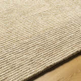 Close up of the hand-tufted Amadi Area Rug in pearl and tan, showing ribbed texture and wool material. Texture
