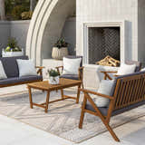 Outdoor patio scene with wood furniture and Beige Areli Area Rug featuring a geometric pattern. Roomscene-Rectangle