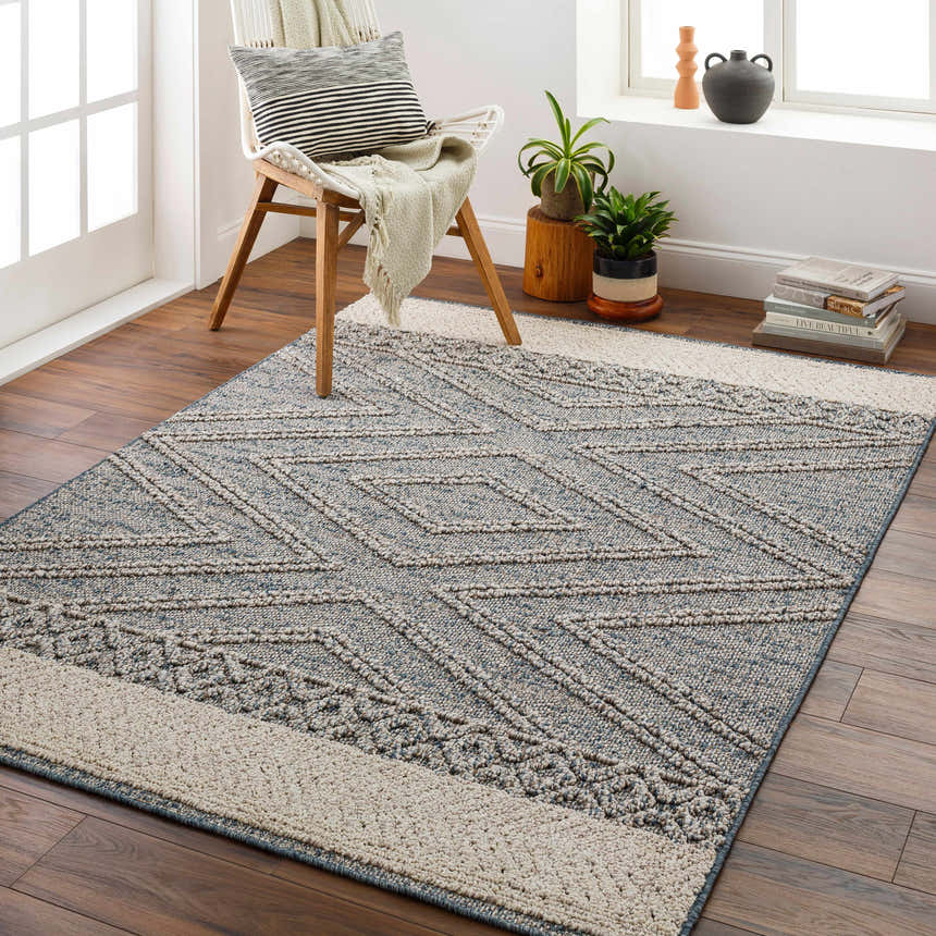 Living room scene with geometric Blue Areli Area Rug, wood floors, chair, and window. Contemporary style. Roomscene-Rectangle
