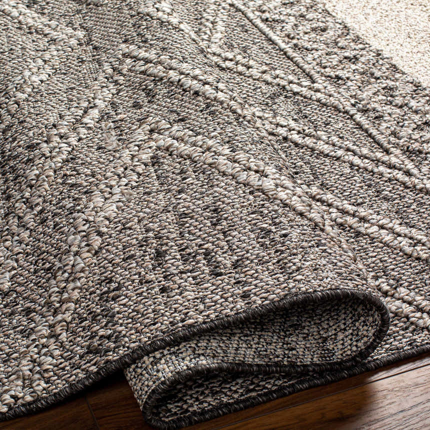 Close-up of the Areli Beige / Brown Outdoor Rug showing its woven texture and geometric pattern. Fold
