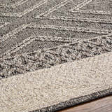 Close-up of the Areli Beige / Brown Outdoor Rug showing the contemporary pattern and textured weave. Texture