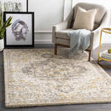 Living room scene with a Stockwell Thick Luxe Rug in ivory, gold, and gray under a chair and side table. Roomscene-Rectangle