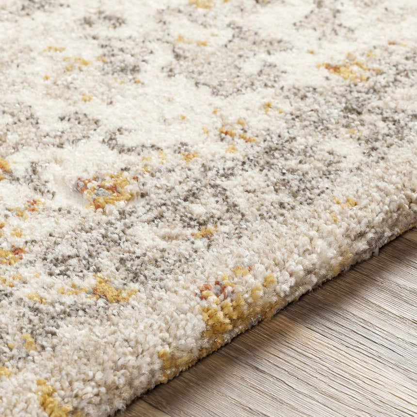 Close-up of the Stockwell Thick Luxe Rug. Ivory rug with a traditional pattern in gold, brown, and brick red tones. Texture