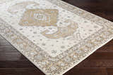 Close-up of the Southwark Area Rug showcasing its beige, off-white, and charcoal traditional pattern on dark wood floors. Corner