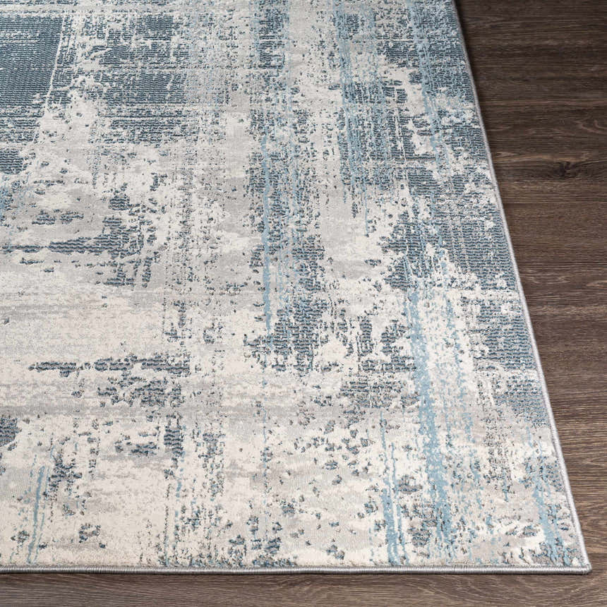 Close-up of the Stokenchurch Area Carpet showing its abstract blue, gray, and white pattern and machine-woven texture. Front