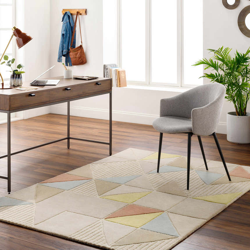 Home office with wood desk and gray chair on Mani Area Rug, a geometric rug in camel, beige, gray, and brown tones. Roomscene-Rectangle